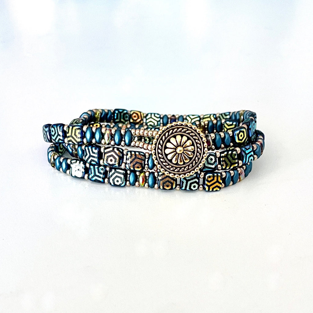 Wrap bracelet made with Czech tiles and super duos of blues, golds and champagne. Finished with a decorative gold button