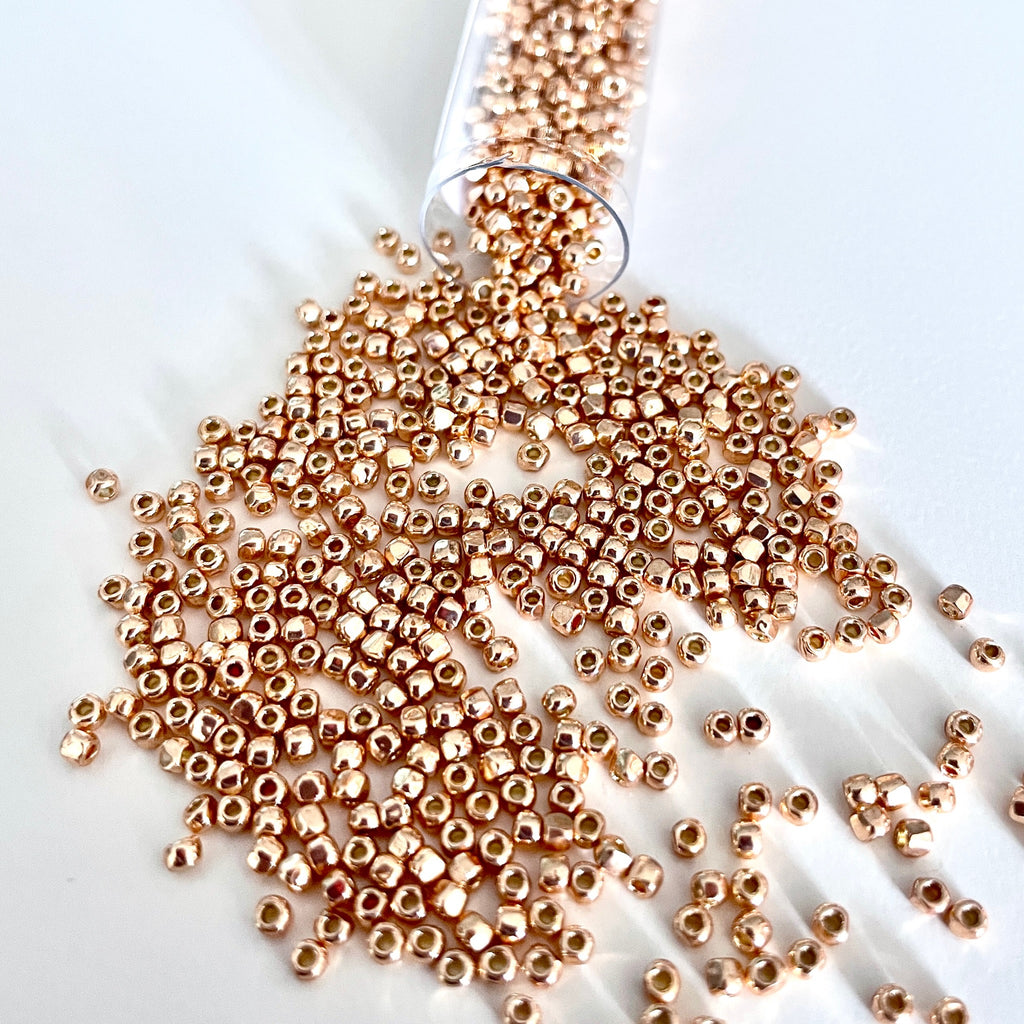 Such a beauty! This 3-cut size 12º rose gold seed bead is a sight to behold. With shimmers from the 3 tiny facets you will think it’s true rose gold. It has a permanent finish so you don’t have to worry about the color wearing off/Island Cove Beads & Gallery