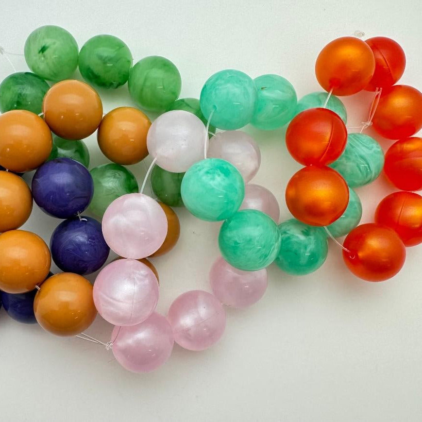Colorful round beads on a white background