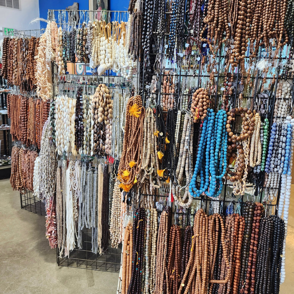 Display of various beaded necklaces in a store setting