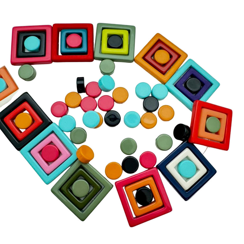 Colorful square and round beads on a light gray background