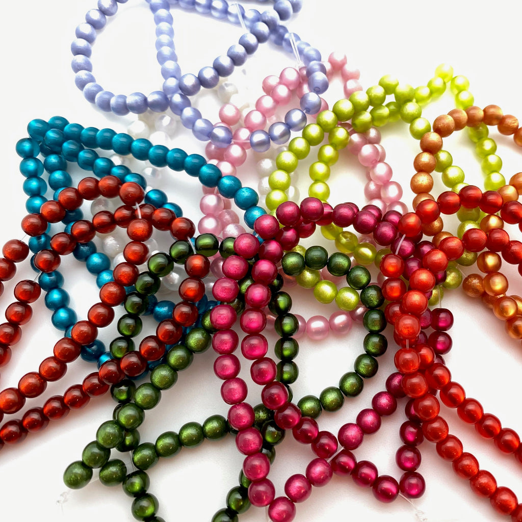 Colorful beaded bracelets on a white background