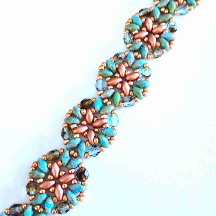 stitched bracelet using superduo beads creating little circles stitched together in copper and turquoise color