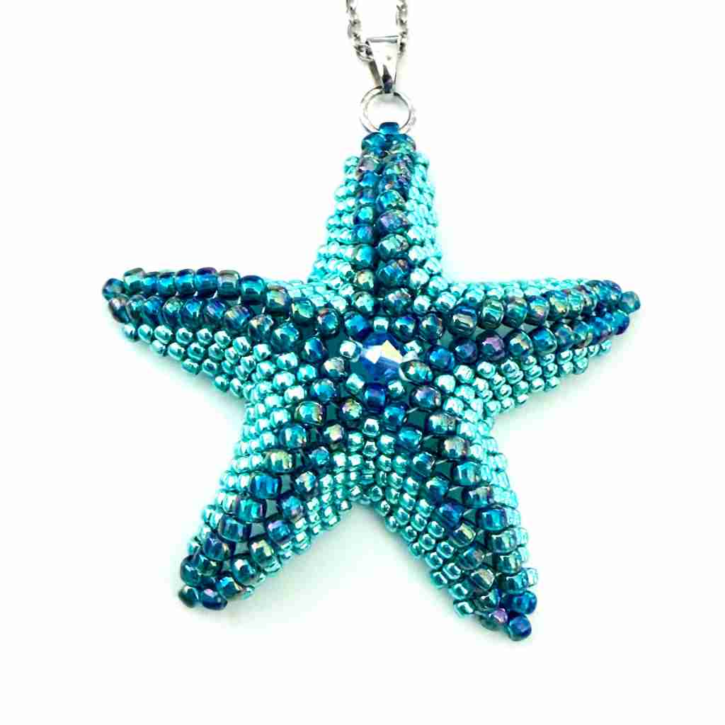 Starfish-shaped pendant made of blue beads on a white background