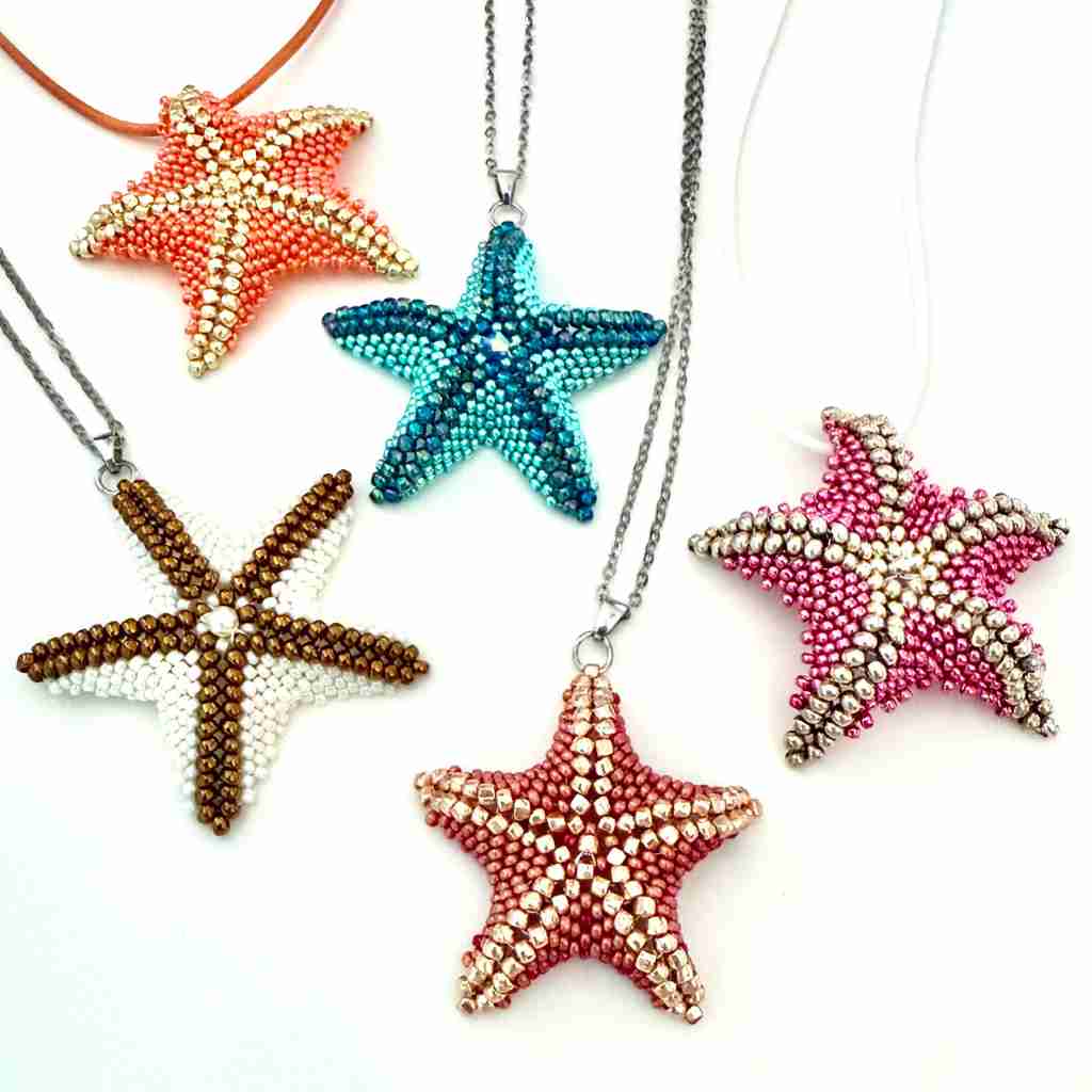 Starfish-shaped necklaces in various colors on a white background