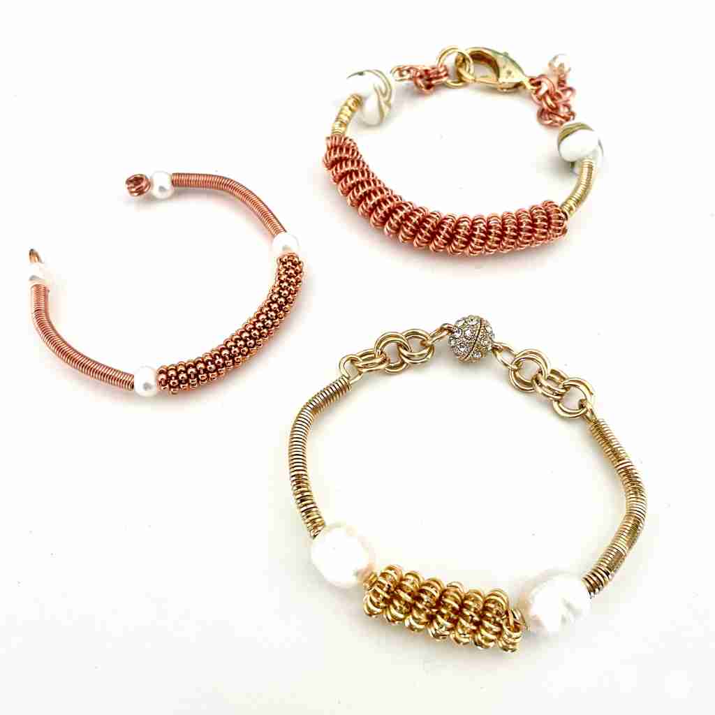copper and brass bracelets made with coiled wire and beads