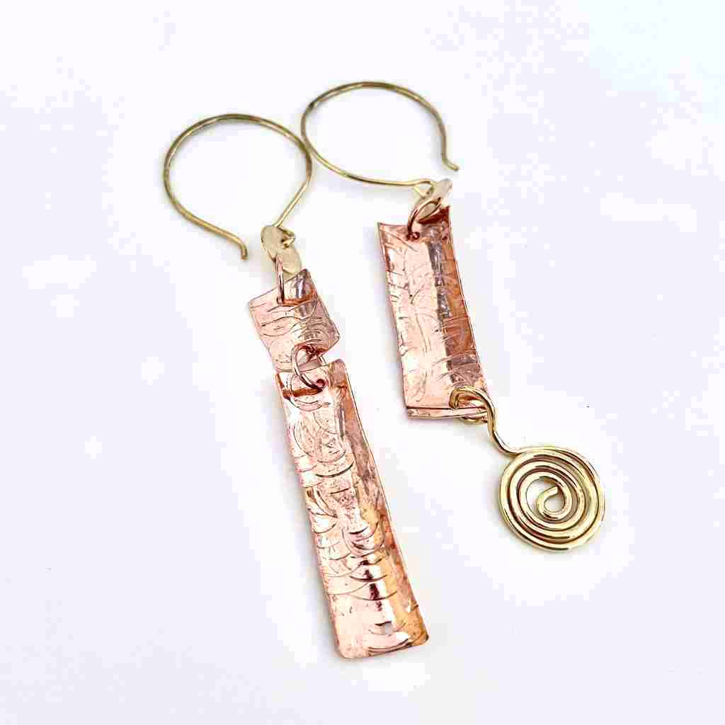 asymmetrical hammered copper earrings with handmade earwires and a spiral charm