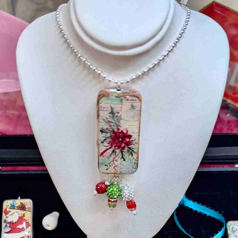 Decorative necklace with a rectangular pendant made from a domino on a mannequin bust.