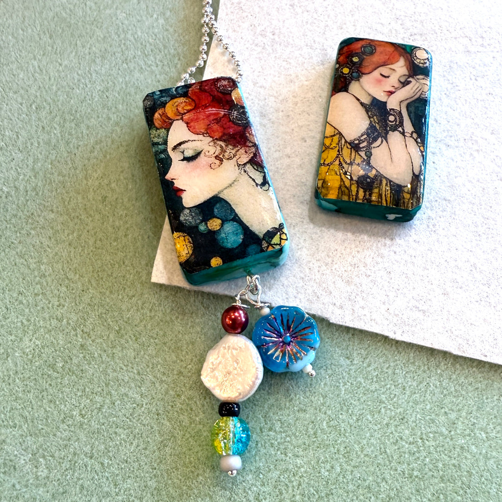 Jewelry set with artistic pendant and beaded necklace on a light green background