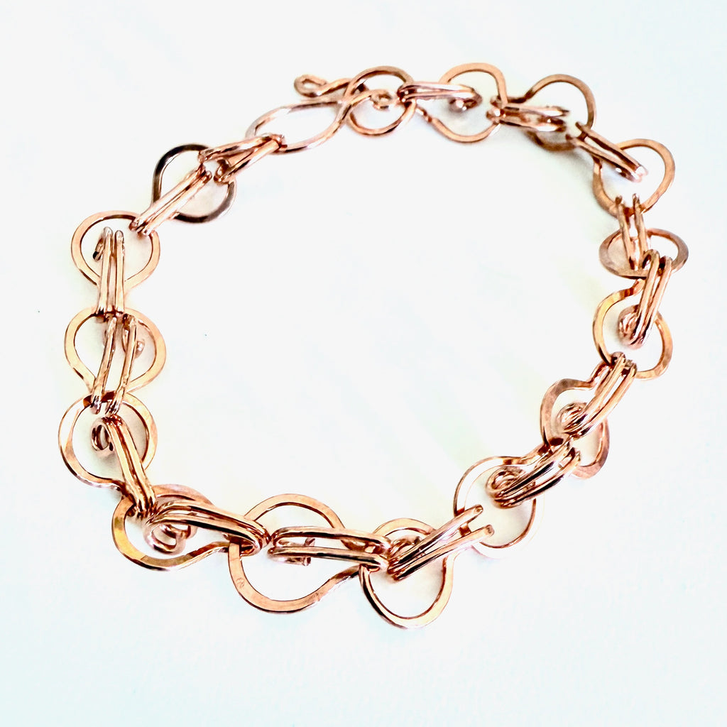 Rose gold chain bracelet on a light background