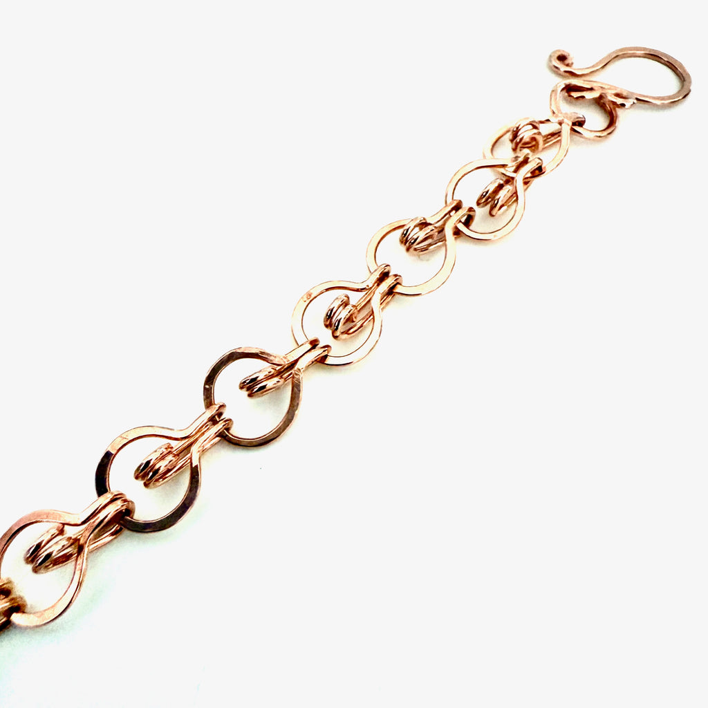 Rose gold chain bracelet on a white background