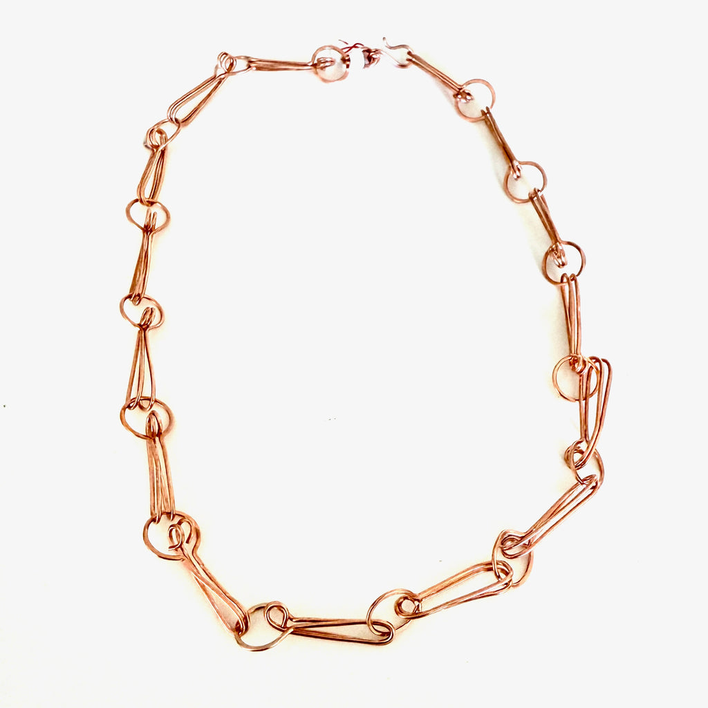 Rose gold chain necklace on a white background