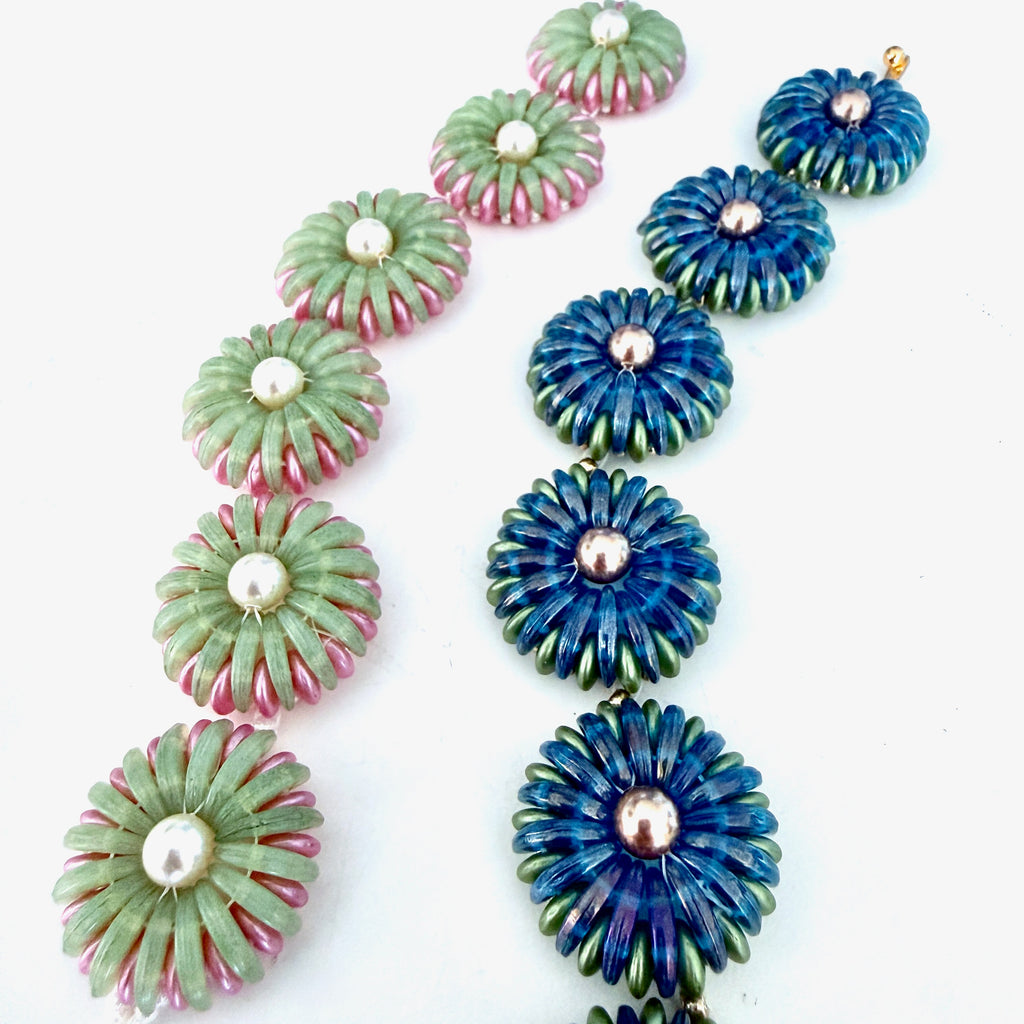 2 Beaded bracelets in shades of greens, pinks, and blues in the shape of chrysanthemum flowers
