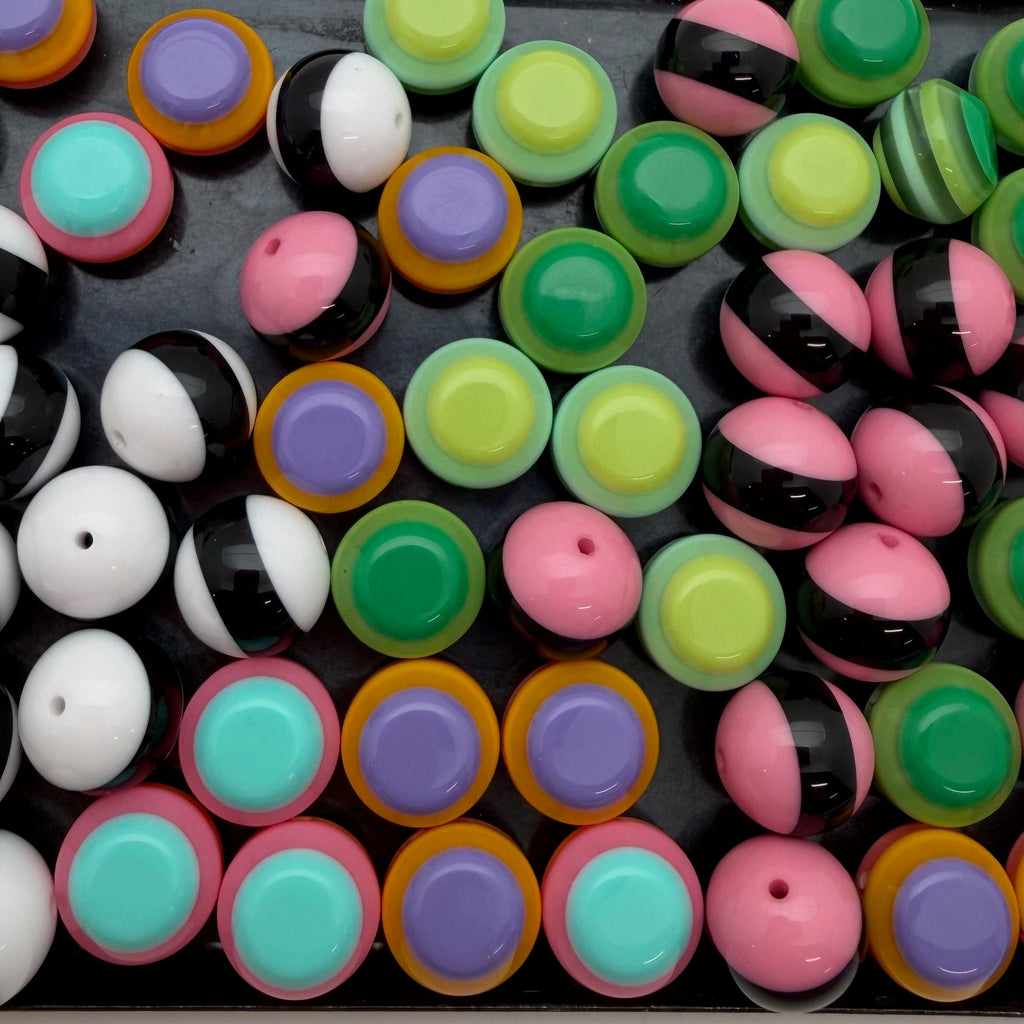 Assorted colorful round beads on a black background