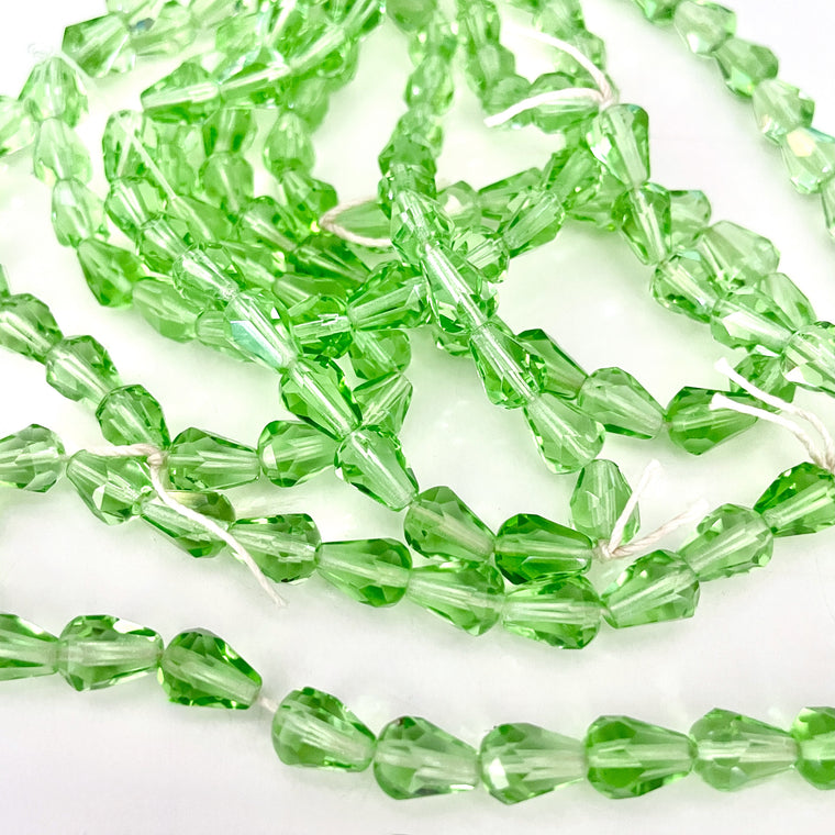 drop shaped Green crystal beads on a white background