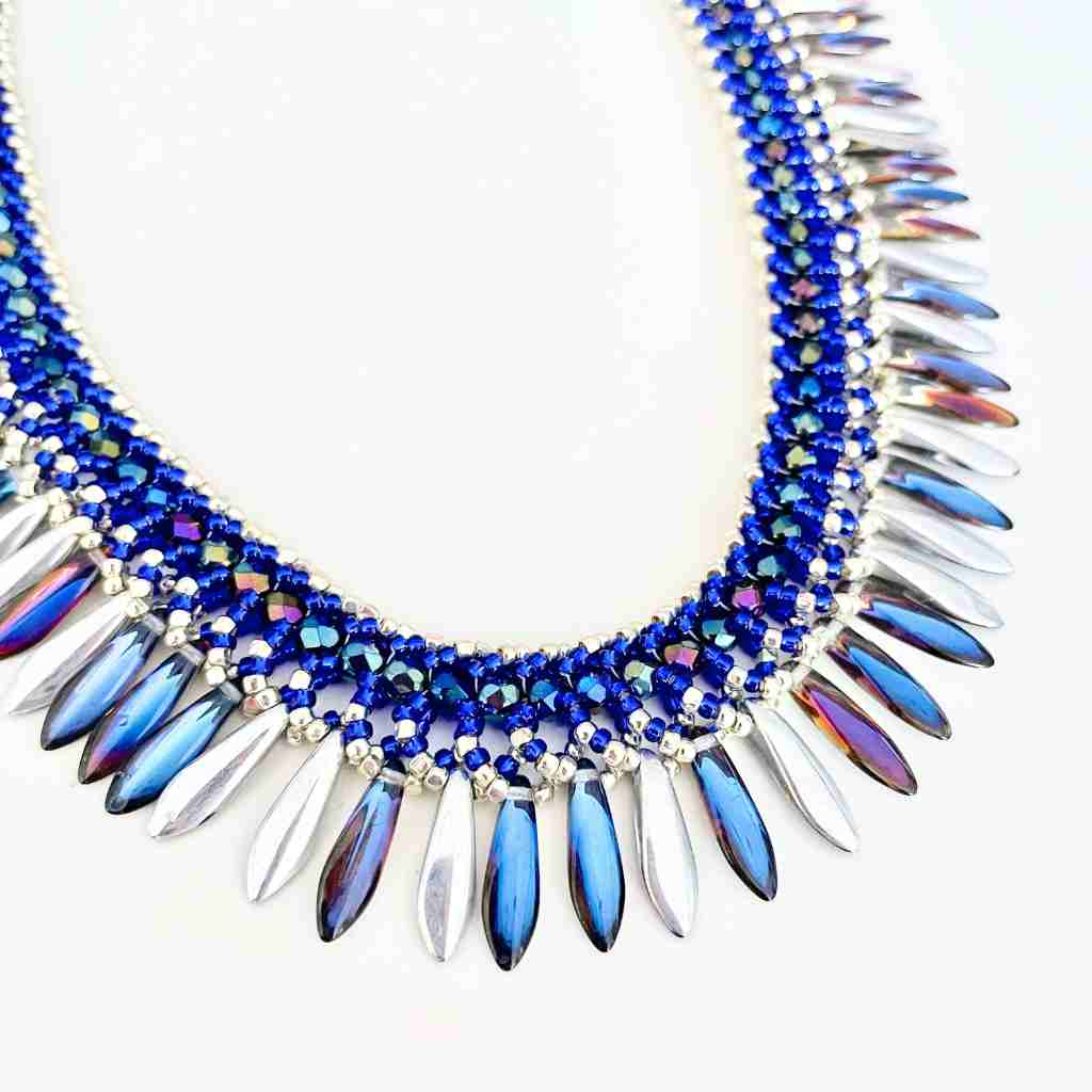 vibrant blue dagger beads with a mirrored finish in a beaded collar style necklace