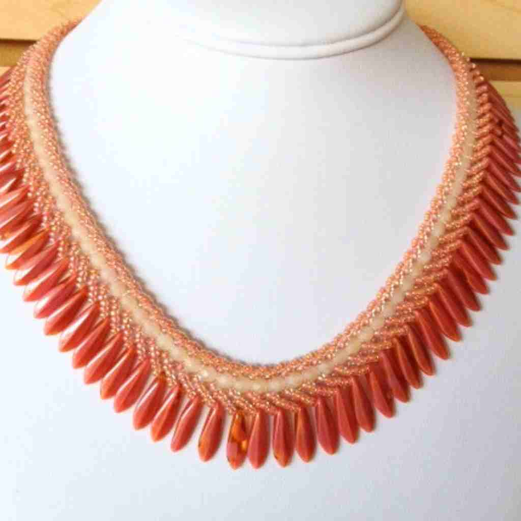 coral colored collar shaped necklace with dagger beads