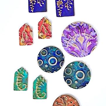 brightly colored metal embossed pendants and charms