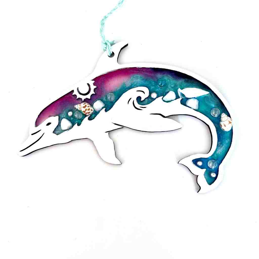 Decorative dolphin ornament with a colorful design on a white background
