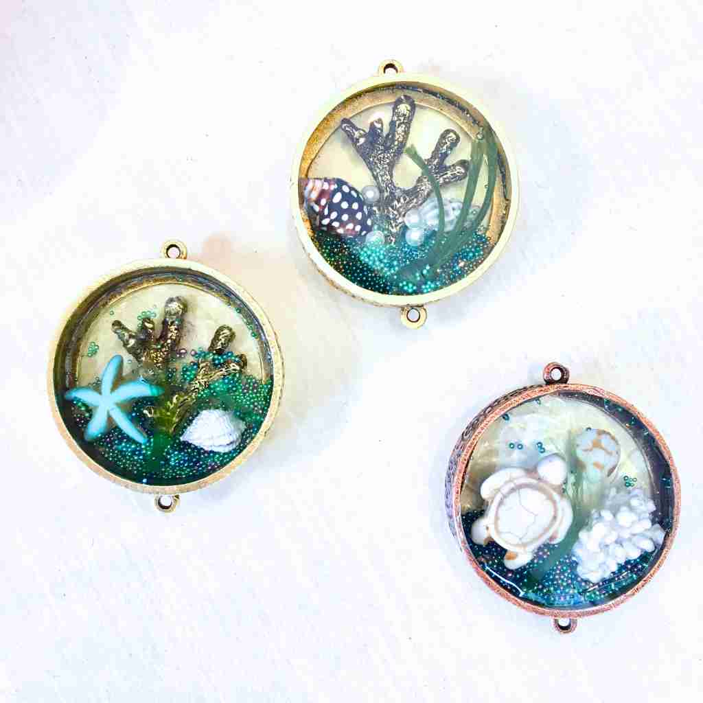 Deep Round metal bezel pendant filled with ocean scene encased in resin