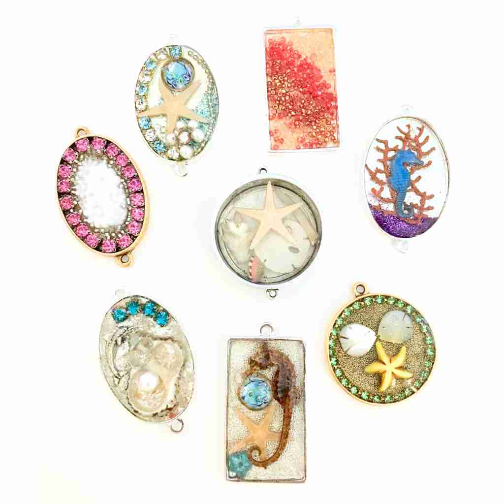 Resin pendants with a seascape theme inside of a metal bezel