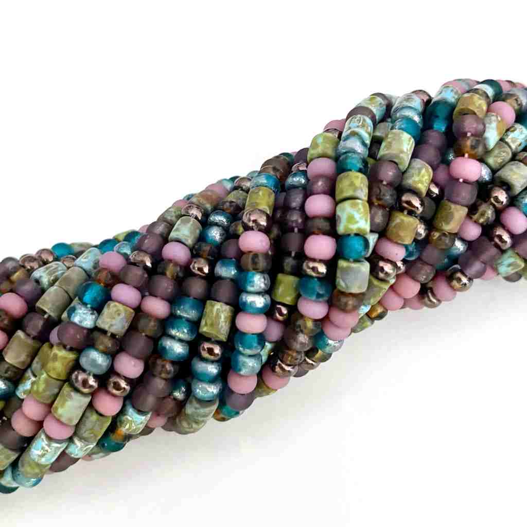 earthy colored matt sead bead strands twisted into a roll